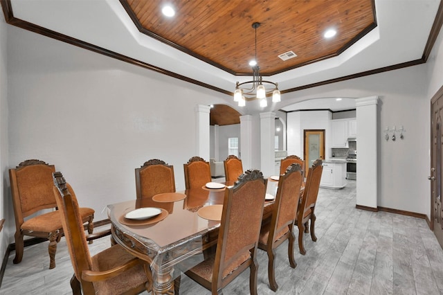 dining room with ornate columns, light hardwood / wood-style flooring, wood ceiling, and a tray ceiling