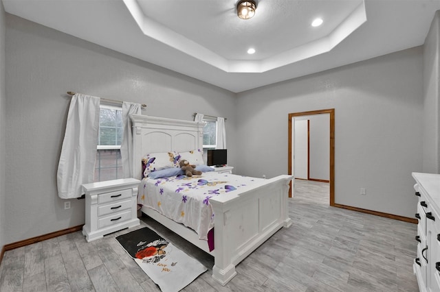 bedroom featuring a raised ceiling