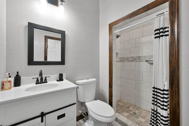 bathroom featuring vanity, toilet, and walk in shower