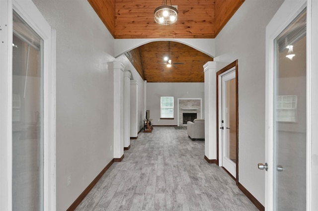 corridor featuring decorative columns, wooden ceiling, vaulted ceiling, and light hardwood / wood-style floors