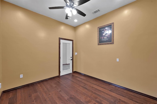 spare room featuring ceiling fan and dark hardwood / wood-style floors