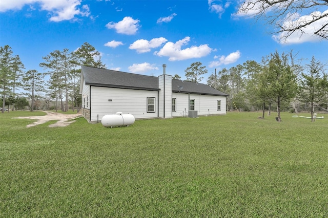 exterior space with a yard and central air condition unit