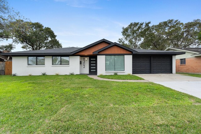 ranch-style house featuring a garage and a front lawn