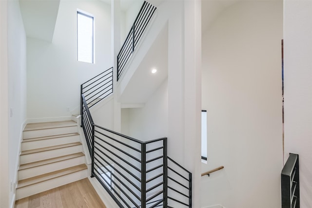 staircase with hardwood / wood-style floors