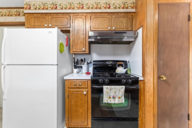 kitchen featuring white fridge and black gas range oven