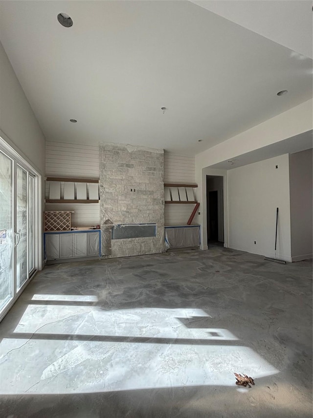 unfurnished living room featuring concrete flooring