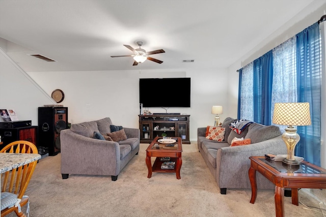 living room with ceiling fan and light colored carpet