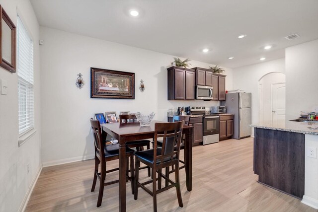 dining space with light hardwood / wood-style floors