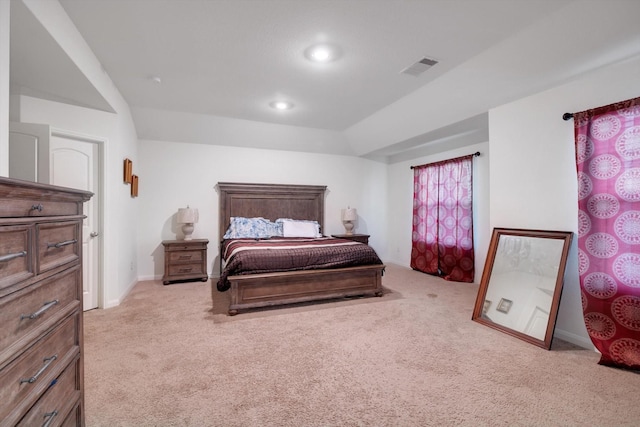 bedroom with light carpet and lofted ceiling