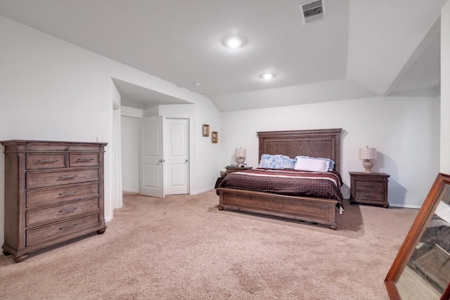 bedroom with light colored carpet and vaulted ceiling