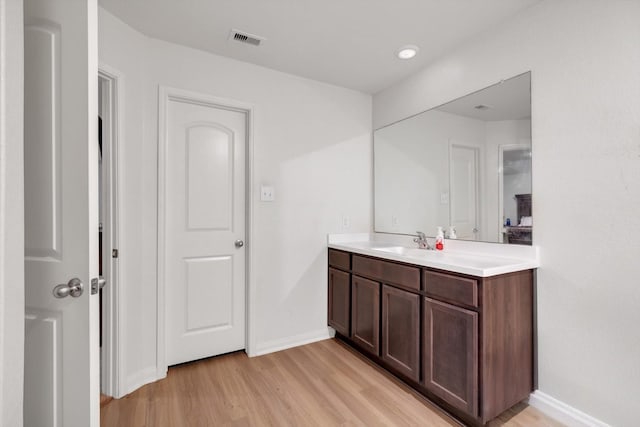 bathroom featuring vanity and hardwood / wood-style flooring