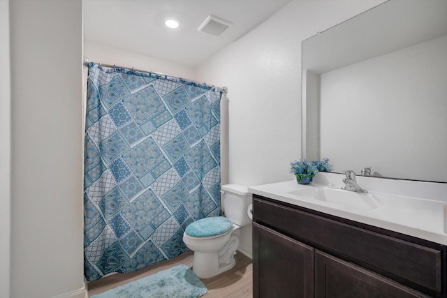 bathroom featuring curtained shower, hardwood / wood-style floors, vanity, and toilet