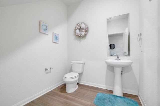 bathroom with wood-type flooring and toilet