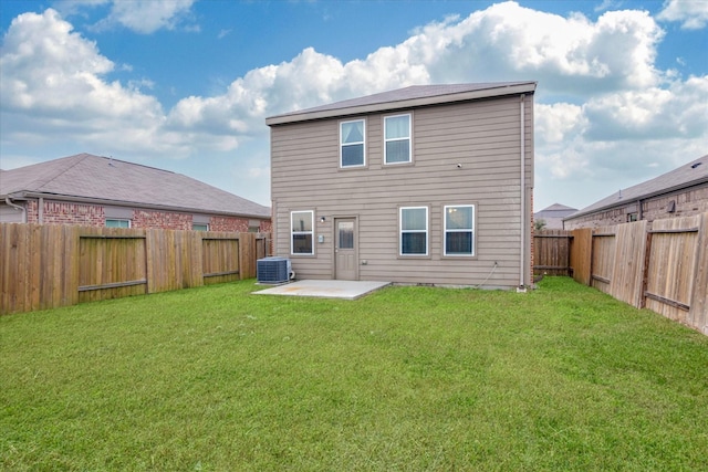 back of property featuring a lawn, a patio area, and central AC unit