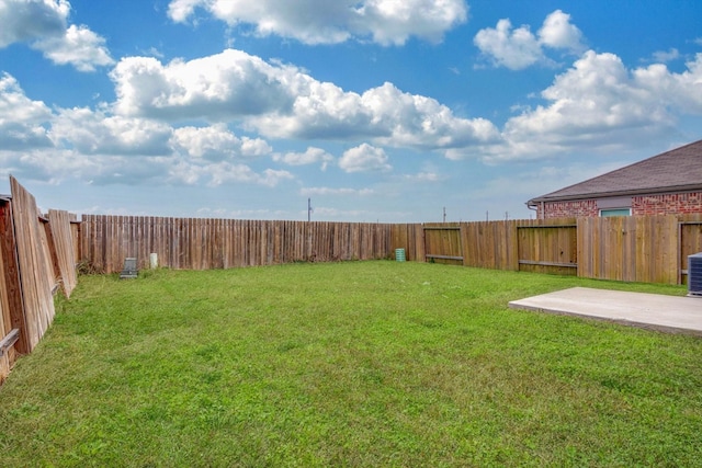 view of yard with cooling unit and a patio area