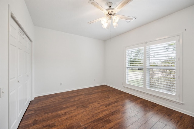 unfurnished bedroom with ceiling fan, a closet, and dark hardwood / wood-style floors