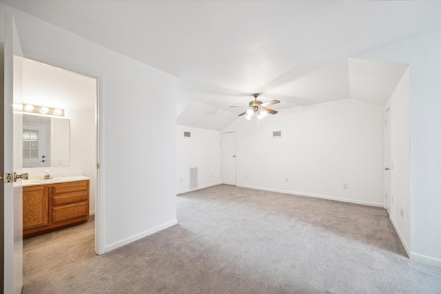 interior space featuring ceiling fan, lofted ceiling, and sink