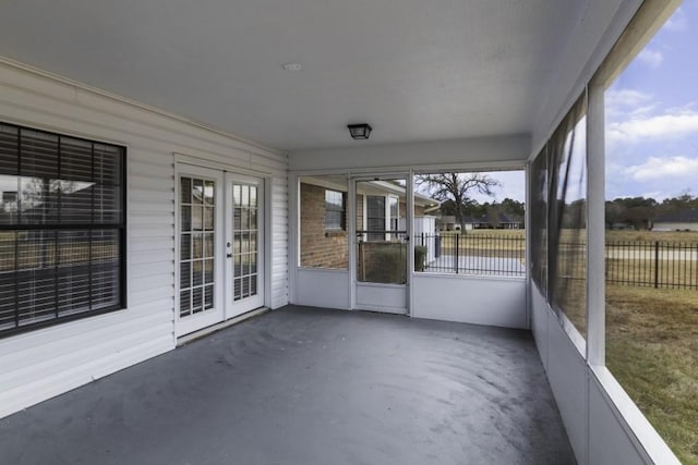 unfurnished sunroom with french doors