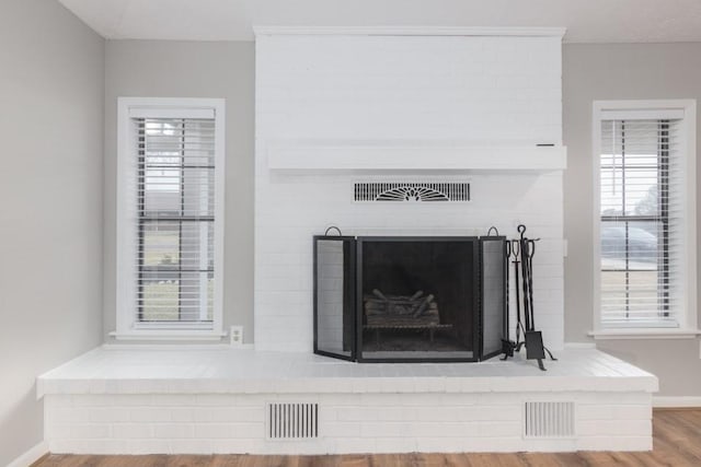 interior details featuring hardwood / wood-style floors and a fireplace