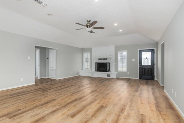 unfurnished living room with ceiling fan, light hardwood / wood-style floors, and lofted ceiling