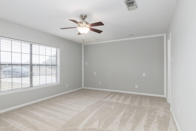 carpeted spare room with ceiling fan