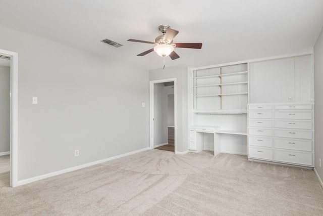 unfurnished bedroom with ceiling fan, light carpet, and a closet