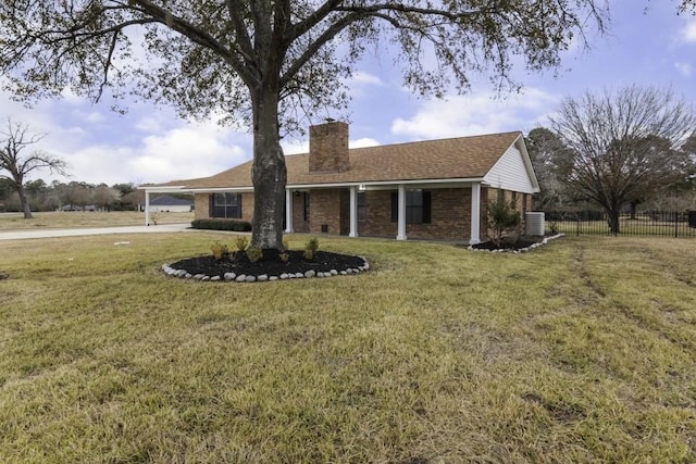 ranch-style house with central AC unit and a front yard