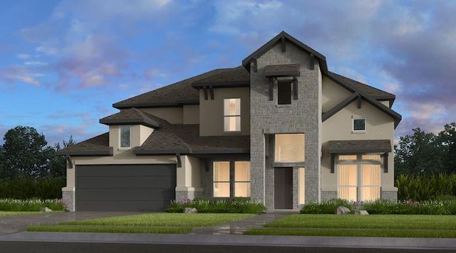 view of front of home featuring a yard and a garage