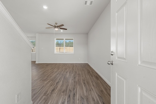 empty room featuring ceiling fan and dark hardwood / wood-style floors