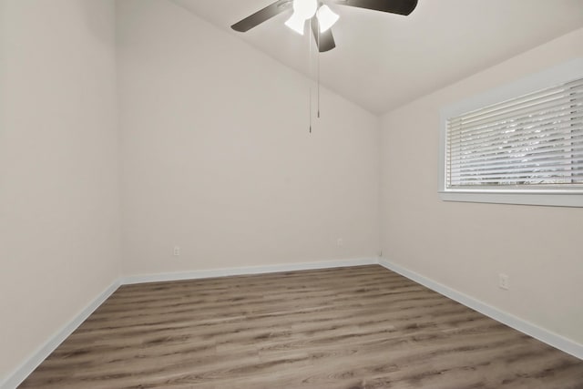 unfurnished room with lofted ceiling, hardwood / wood-style flooring, and ceiling fan