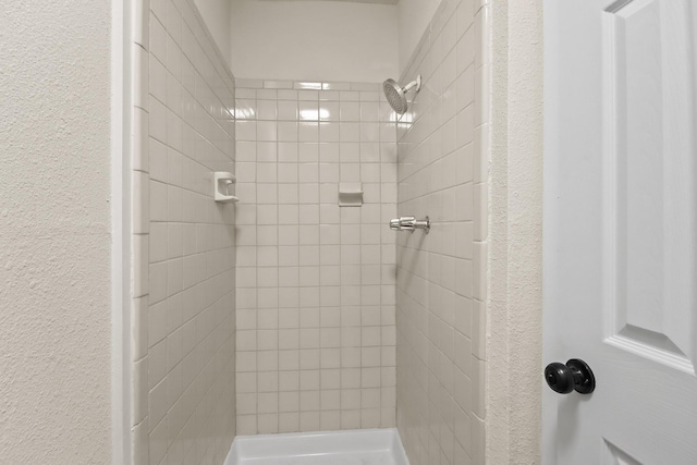 bathroom with a tile shower