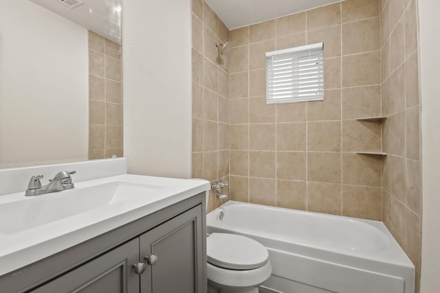 full bathroom featuring vanity, toilet, and tiled shower / bath combo