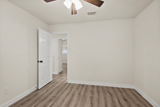 empty room featuring ceiling fan and light wood-type flooring