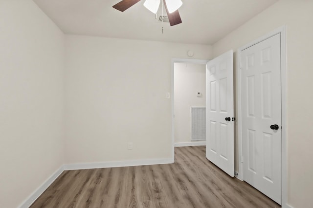 unfurnished bedroom with ceiling fan and light hardwood / wood-style floors