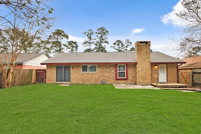 rear view of house featuring a yard