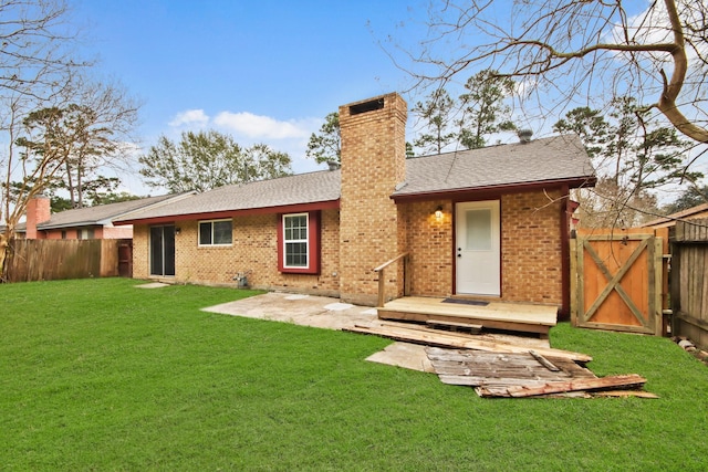 back of property featuring a yard and a patio