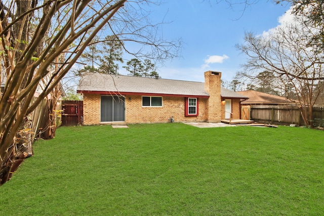 rear view of house with a lawn