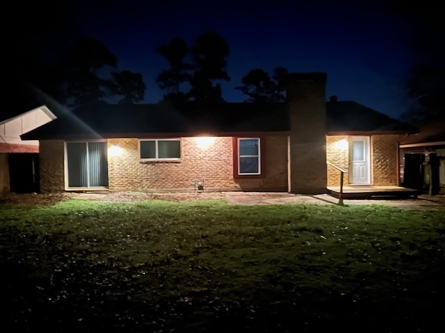 back house at night with a lawn