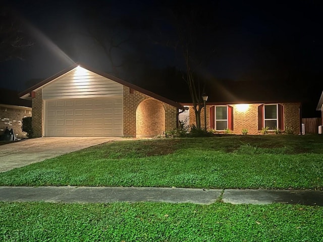 view of front facade with a garage and a yard