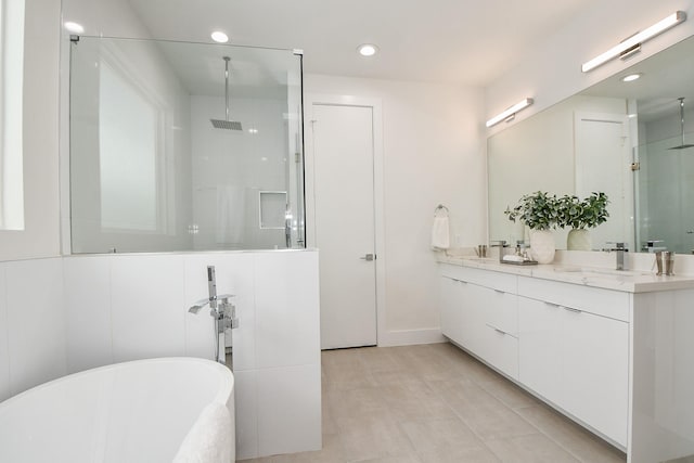 bathroom featuring tile patterned flooring, shower with separate bathtub, and vanity