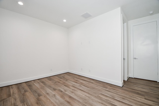 spare room with hardwood / wood-style floors