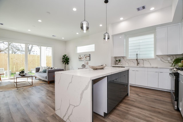 kitchen featuring white cabinetry, stainless steel range with electric cooktop, and a kitchen island