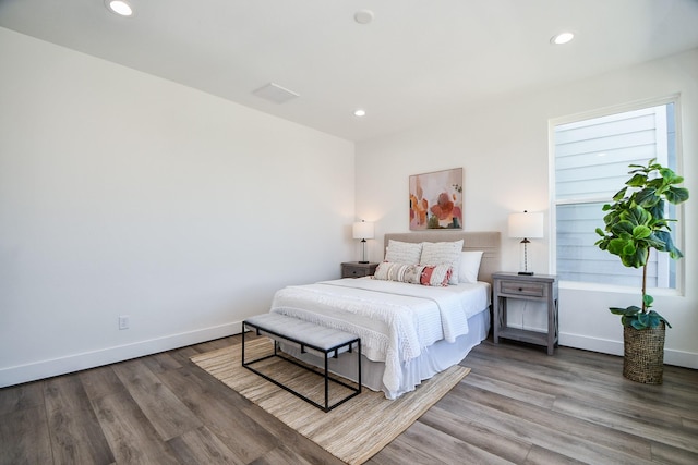 bedroom featuring hardwood / wood-style floors and multiple windows