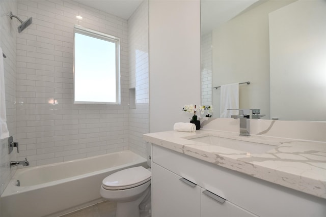 full bathroom with toilet, plenty of natural light, vanity, and tiled shower / bath