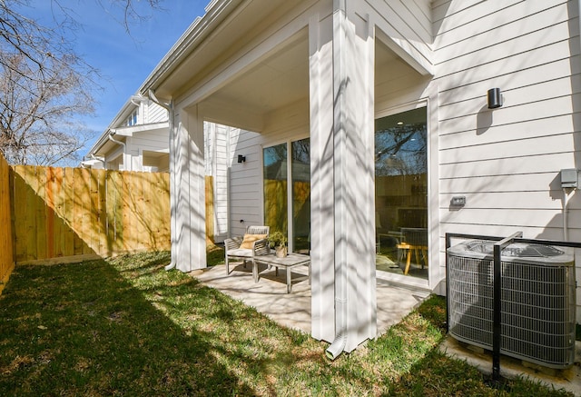 back of house featuring a patio, central AC, and a lawn