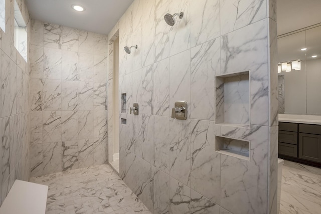 bathroom with vanity and tiled shower