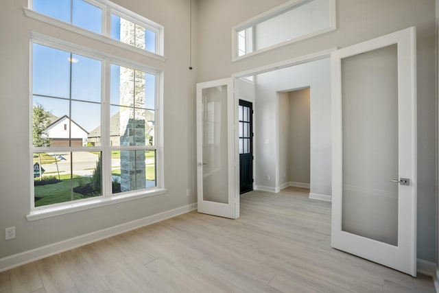 interior space with french doors and light hardwood / wood-style flooring