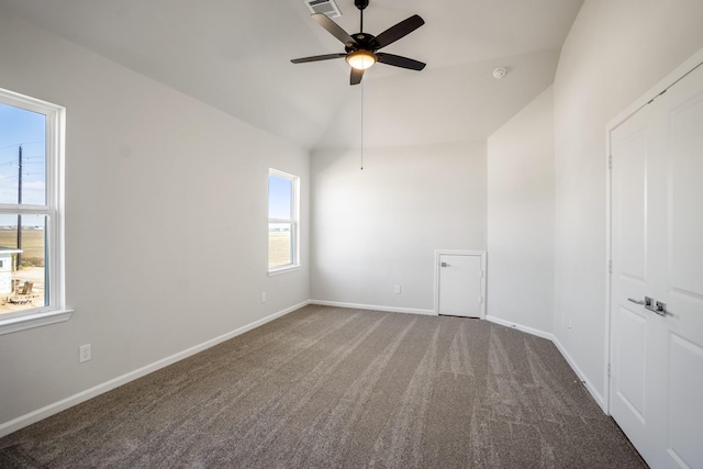 unfurnished room with carpet, vaulted ceiling, and ceiling fan