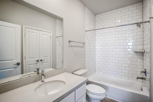 full bathroom with toilet, vanity, and tiled shower / bath