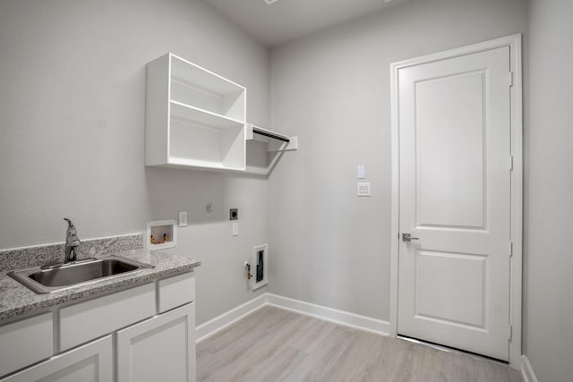 washroom featuring hookup for an electric dryer, hookup for a washing machine, sink, light hardwood / wood-style flooring, and hookup for a gas dryer